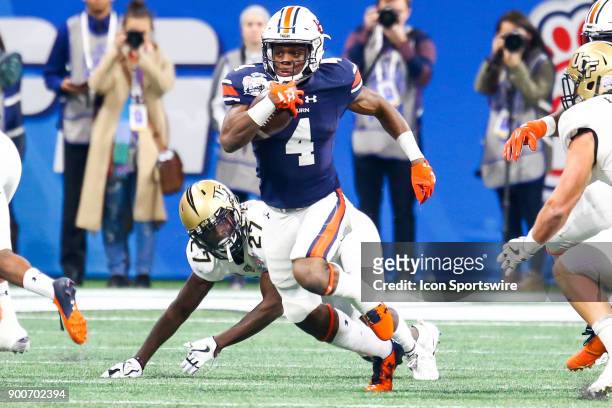 Auburn Tigers wide receiver Noah Igbinoghene runs the ball after a catch during the 2017 Chick-fil-A Peach Bowl football game between The University...