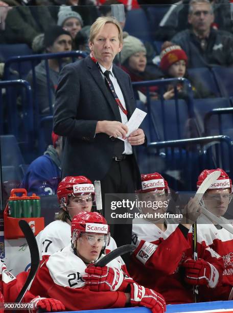 Denmark head coach Olaf Eller on the bench in the second period against Finland during the IIHF World Junior Championship at KeyBank Center on...