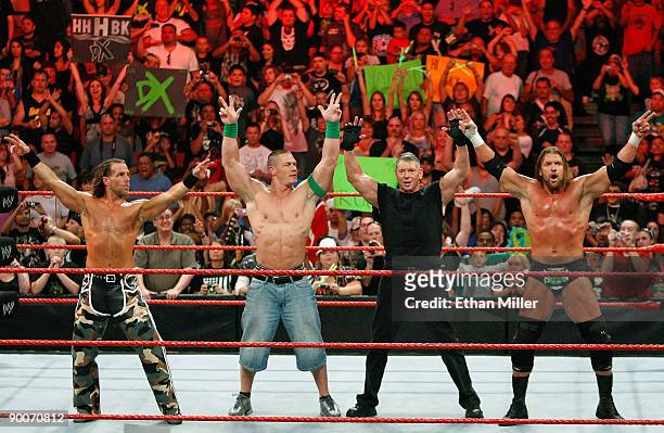 Wrestler Shawn Michaels, World Wrestling Entertainment Inc. Chairman Vince McMahon, and wrestlers John Cena and Triple H pose in the ring during the...