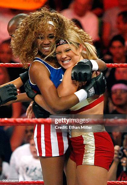 Wrestlers Alicia Fox and Beth Phoenix celebrate a tag team match win during the WWE Monday Night Raw show at the Thomas & Mack Center August 24, 2009...