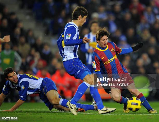 Barcelona's Argentinian forward Lionel Messi vies with Espanyol's Argentinian defender Juan Forlin and Espanyol's midfielder Julian Amat during the...