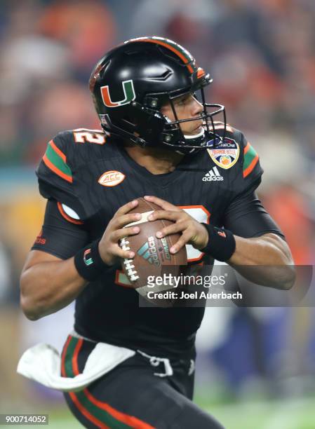 Malik Rosier of the Miami Hurricanes looks upfield as he runs out of the pocket with the ball against the Wisconsin Badgers during the 2017 Capital...