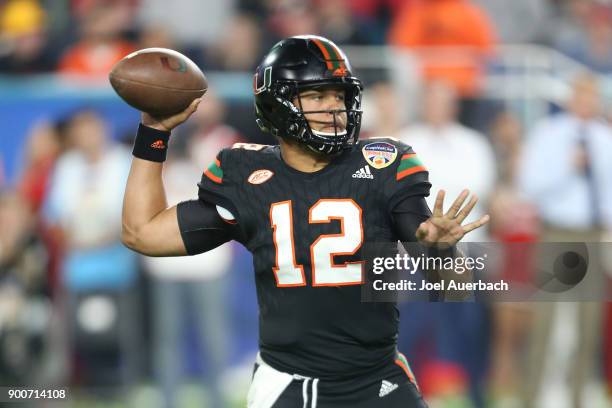 Malik Rosier of the Miami Hurricanes throws the ball against the Wisconsin Badgers during the 2017 Capital One Orange Bowl at Hard Rock Stadium on...