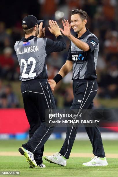 New Zealand's Kane Williamson and Trent Boult celebrate the wicket of West Indies batsman Jerome Taylor during the third Twenty20 international...