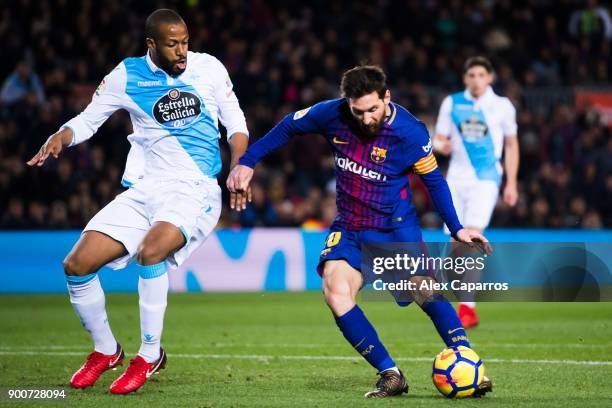 Lionel Messi of FC Barcelona shoots the ball under pressure from Sidnei of Deportivo La Coruna during the La Liga match between FC Barcelona and...