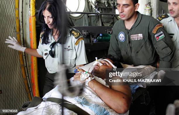 Medics with the Royal Jordanian Air Force carry an Iraqi man who was wounded in Baghdad's recent blasts, upon his arrival at Marka military airport...