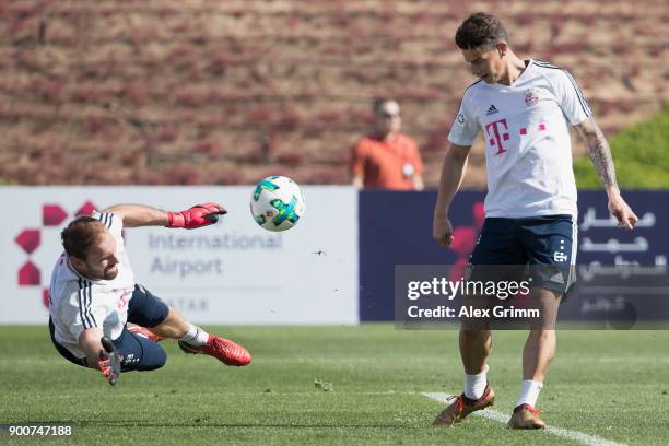 James Rodriguez scores a goal past goalkeeper Tom Starke during a training session on day 2 of the FC Bayern Muenchen training camp at ASPIRE Academy...