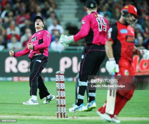 Jason Roy of the Sixers runs out Aaron Finch of the Renegades during the Big Bash League match between the Melbourne Renegades and the Sydney Sixers...
