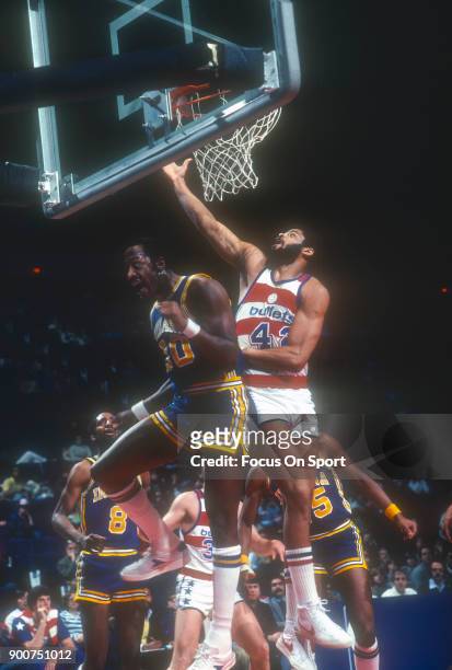 Greg Ballard of the Washington Bullets shoots over George McGinnis of the Indiana Pacers during an NBA basketball game circa 1980 at the Capital...