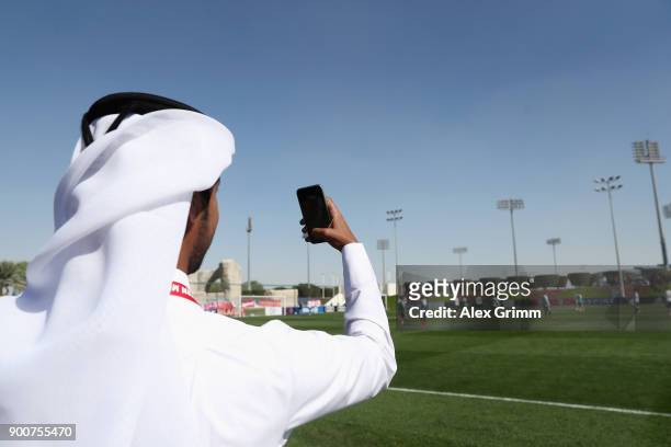 Man takes a picture during a training session on day 2 of the FC Bayern Muenchen training camp at ASPIRE Academy for Sports Excellence on January 3,...