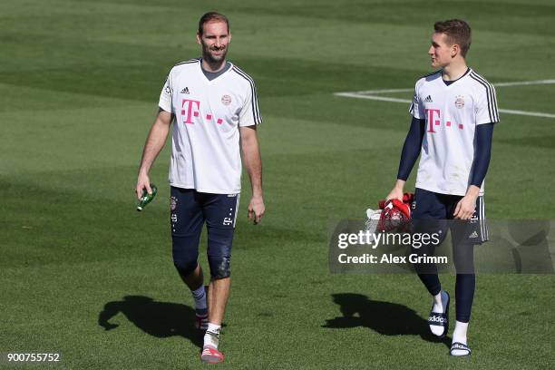 Goalkeepers Tom Starke and Ron Thorben Hoffmann leave after a training session on day 2 of the FC Bayern Muenchen training camp at ASPIRE Academy for...