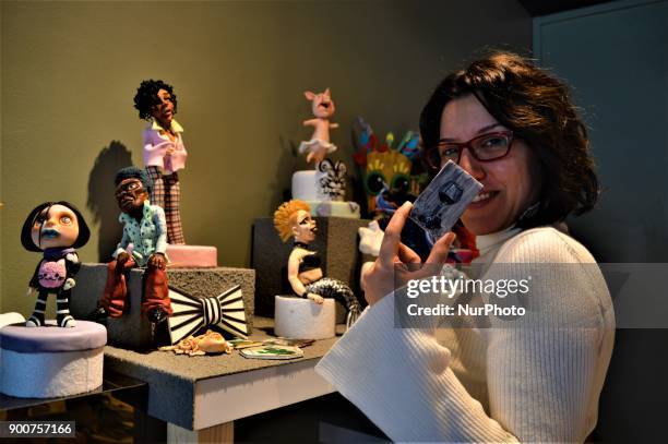 Multi-award-winning Turkish sugar artist Ayca Duman Kaleli shows a figure made from sugar paste as she poses for a photo at her cake design workshop...