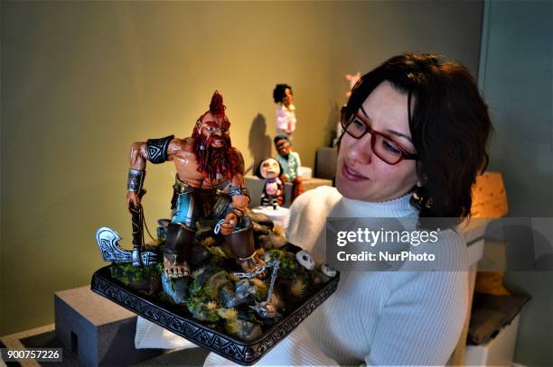 Multi-award-winning Turkish sugar artist Ayca Duman Kaleli shows an award-winning figure made from sugar paste as she poses for a photo at her cake...