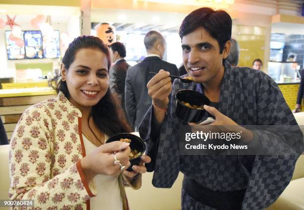 Visitors to Tokyo Table, a Japanese restaurant, in New Delhi taste a Japanese-style curry dish in December 2017. The restaurant opened at a food...