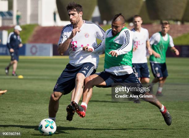 Javi Martinez is challenged by Arturo Vidal during a training session on day 2 of the FC Bayern Muenchen training camp at ASPIRE Academy for Sports...