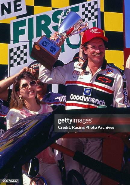 Dale Earnhardt holds the trophy in victory lane and takes home $51,225 for the win at North Wilkesboro, North Carolina on April 16, 1989.