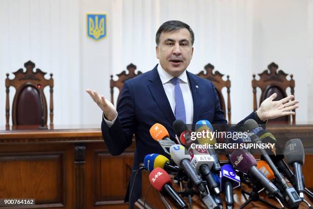 Former Georgian president Mikheil Saakashvili gestures as he speaks to the media prior to the start of his appeal hearing at a courthouse in Kiev on...