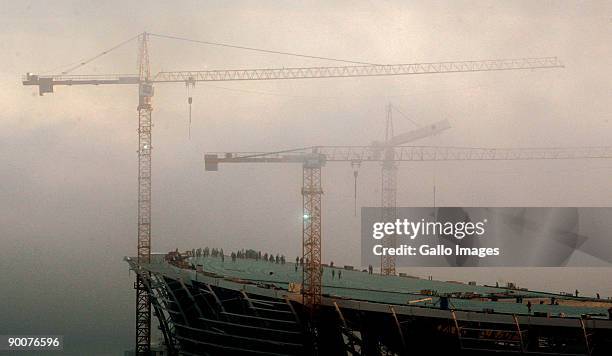 Construction cranes towering over the Green Point Stadium in Cape Town, South Africa, hovers in a bank of fog on 25 August 2009 in Cape Town, South...
