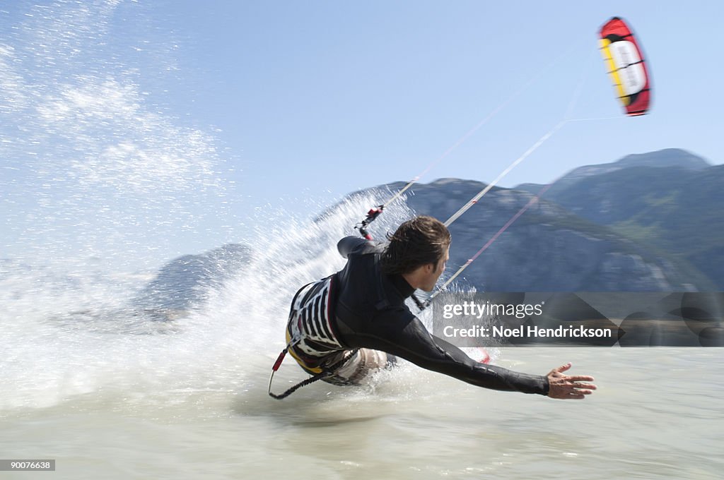 Man kiteboarding, on water