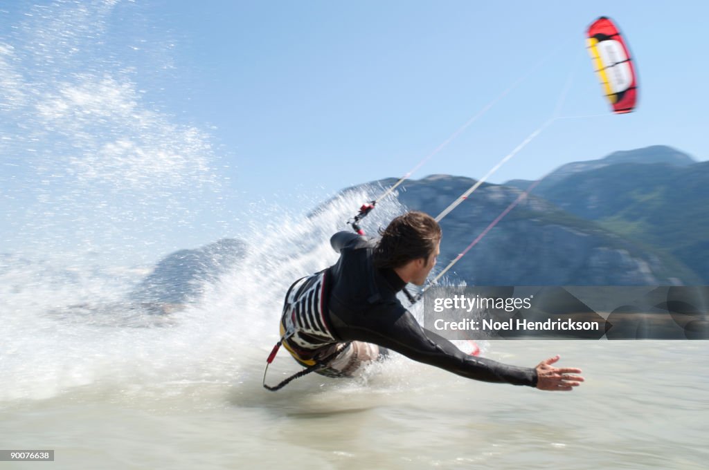 Man kiteboarding, on water