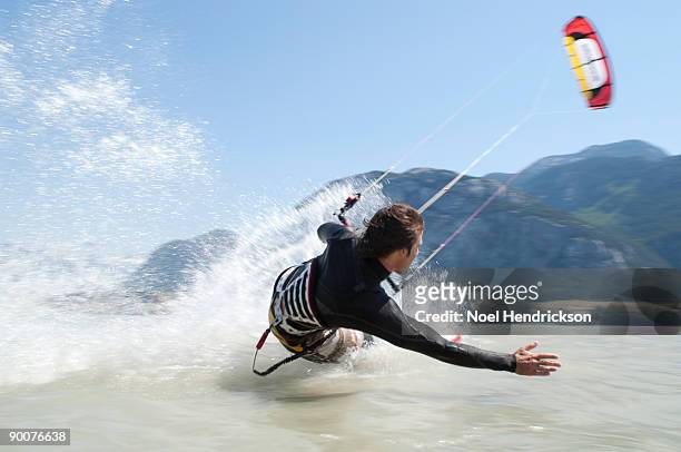 man kiteboarding, on water - kite stock pictures, royalty-free photos & images