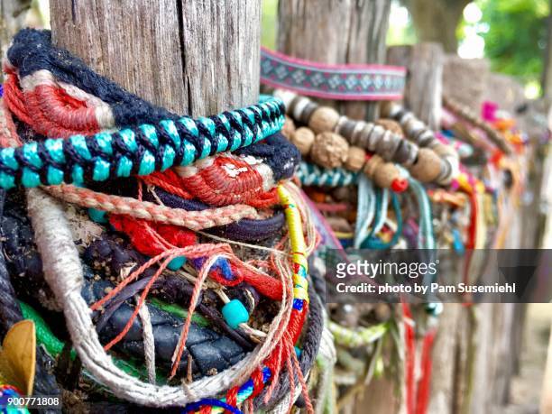 bracelets left by visitors at choeung ek killing fields, cambodia - cambodian khmer rouge tourism stock pictures, royalty-free photos & images