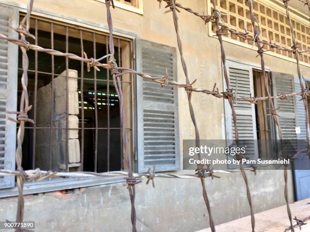 barbed wire enclosed building, tuol sleng genocide museum, phnom penh - cambodian khmer rouge tourism stock pictures, royalty-free photos & images