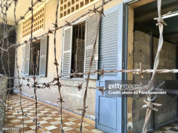 barbed wire enclosed building, tuol sleng genocide museum, phnom penh - cambodian khmer rouge tourism stock pictures, royalty-free photos & images