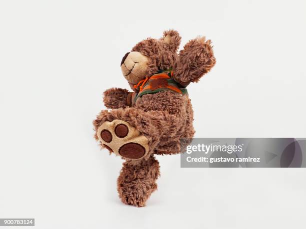 brown stuffed bear kicking - teddy bear stock pictures, royalty-free photos & images