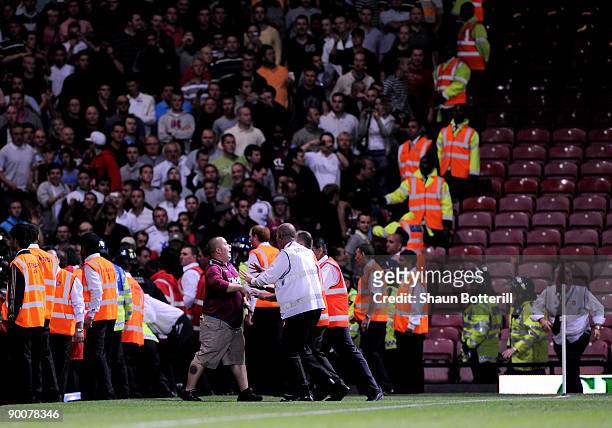 West Ham United fan confronts the stewards during the Carling Cup second round match between West Ham United and Millwall which was marred by...