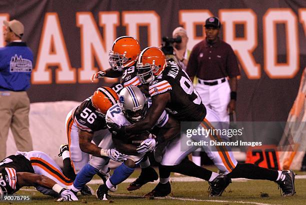 Wide receiver Derrick Williams of the Detroit Lions is gang-tackled by linebacker Kaluka Maiava, defensive back Bret Lockett and linebacker Leon...