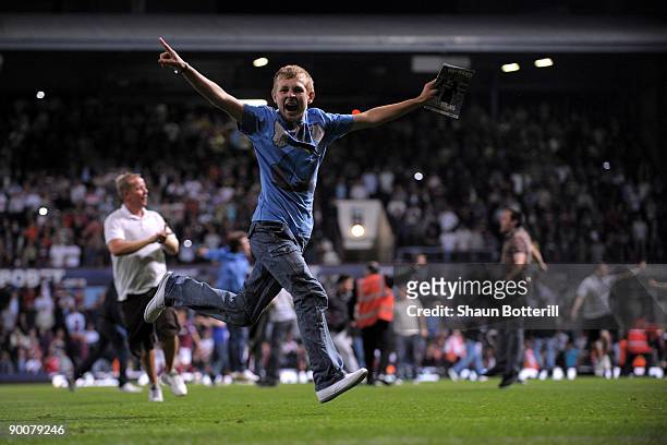 Fans invade the pitch during the Carling Cup second round match between West Ham United and Millwall at Upton Park on August 25, 2009 in London,...