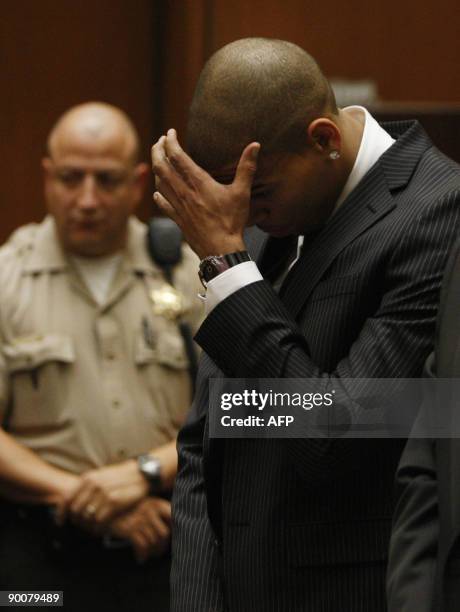 Singer Chris Brown reacts as he listens inside the Los Angeles Superior Court during sentencing in his felony assault case against Rihanna, on August...