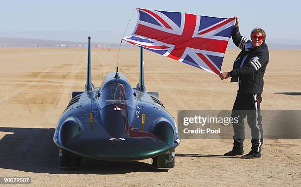 The financial backer and driver of The British Steam Car Challenge team Charles Burnett III celebrates beside his vehicle after breaking the land...