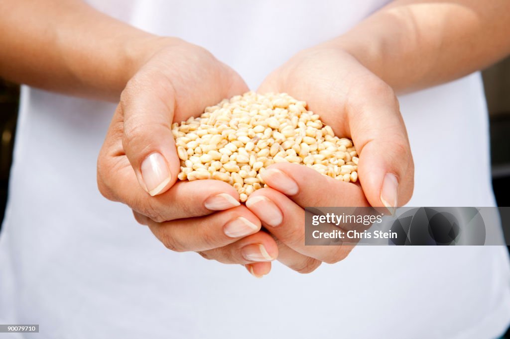 Woman holding wheat seeds