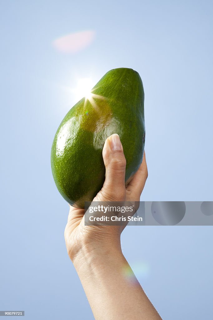 Woman holding Avocado