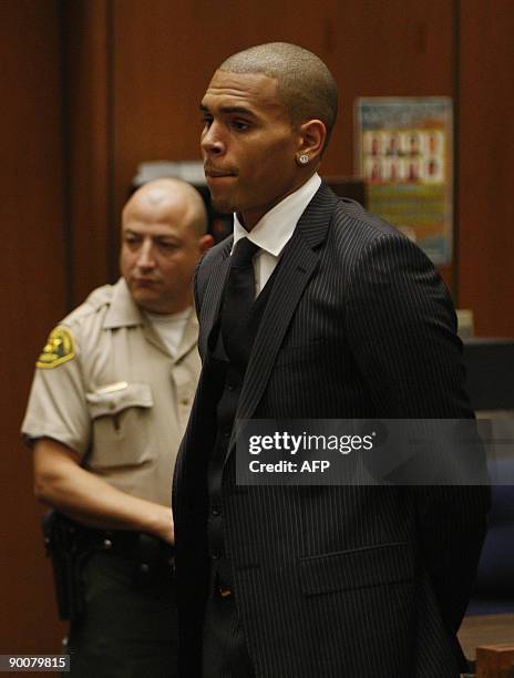 Singer Chris Brown listens inside the Los Angeles Superior Court during the sentencing in his felony assault case against Rihanna, on August 25,...