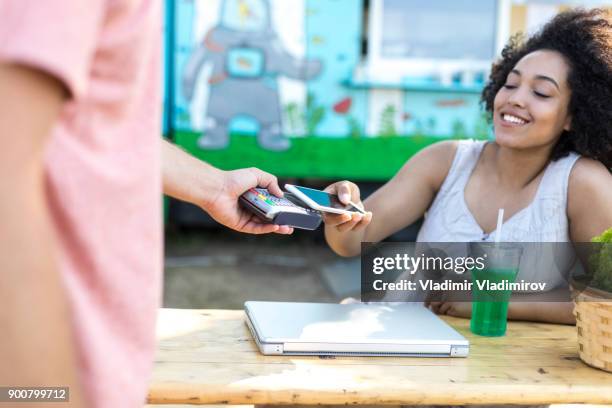 woman drinking cocktail and using credit card - food truck payments stock pictures, royalty-free photos & images