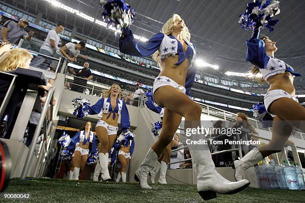 The Dallas Cowboys Cheerleaders take to the field during a preseason game against the Tennessee Titans at Dallas Cowboys Stadium on August 21, 2009...