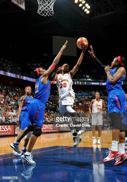 Tan White of the Connecticut Sun shoots the basketball against Taj McWilliams of the Detroit Shock during the WNBA game on August 25, 2009 at the...