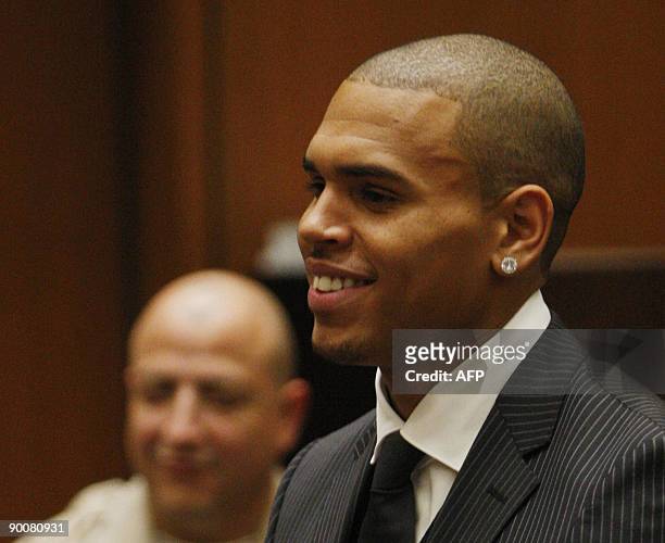 Singer Chris Brown smiles inside the Los Angeles Superior Court during the sentencing in his felony assault case against Rihanna, on August 25, 2009....