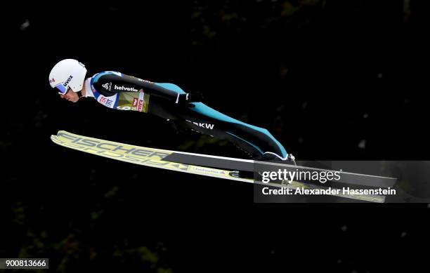 Simon Ammann of Switzerland soars through the air during his qualification jump on day one of the Innsbruck 65th Four Hills Tournament on January 3,...