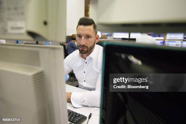 Christopher Sornberger, a specialist in floor equities at Oddo Seydler Bank AG, monitors financial data as the second iteration of the Markets in...