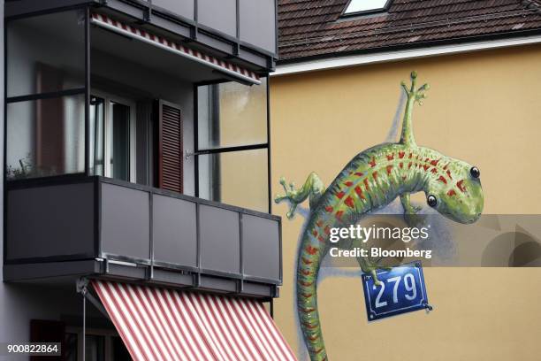 Painted lizard wall mural stands on the exterior of a residential apartment block in Bern, Switzerland, on Wednesday, Jan. 3, 2018. The supply of...