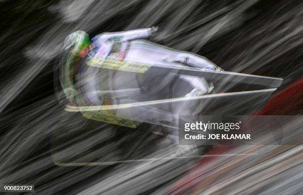 Multi-exposure picture shows Peter Prevc of Slovenia jumping during the qualifying round of the third stage at the 66th Four Hills Tournament in...