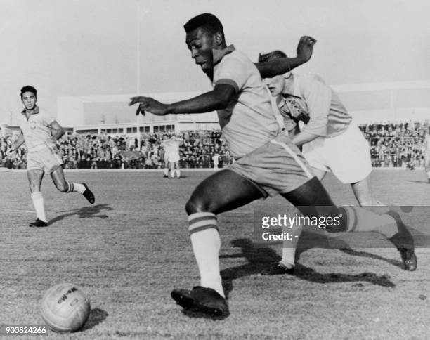 Brazilian forward Pele dribbles past a defender during a friendly match between Malmoe and Brazil, on May 8, 1960 in Malmoe. - Pele scored two goals...