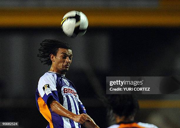 Costa Rican Michael Barrantes of Saprissa heads the ball during their Concacaf Champion League Football match against Puerto Rican Islanders, in San...