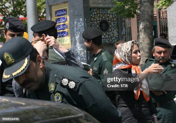 Iranian policemen warn women about their clothing and hair during a crackdown to enforce Islamic dress code in Tehran 22 April 2007. Iran has issued...