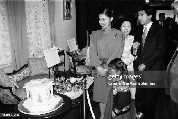 Prince Takamado, Princess Hisako and their daughter Princess Tsuguko visit a confectionery exhibition at Daimaru Museum on February 11, 1991 in...