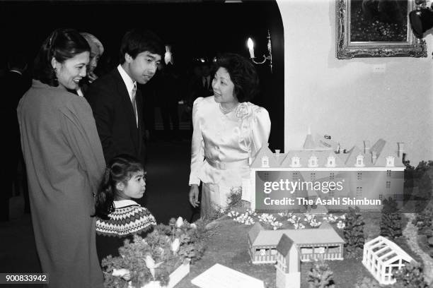 Prince Takamado, Princess Hisako and their daughter Princess Tsuguko visit a confectionery exhibition at Daimaru Museum on February 11, 1991 in...